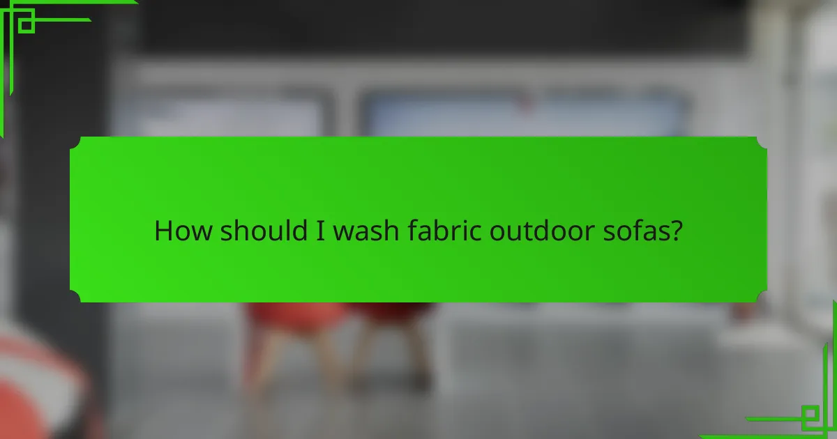 How should I wash fabric outdoor sofas?